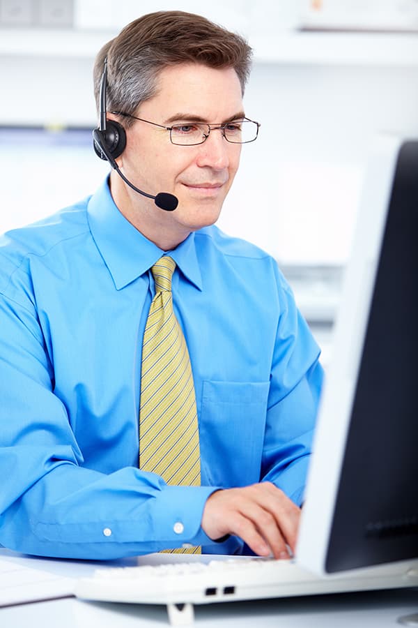 male working at home with headset and computer